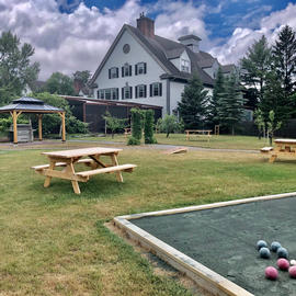 picture of picnic table on lawn behind the essex resort
