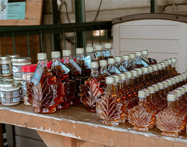 rows of maple leaf shaped maple syrup bottles