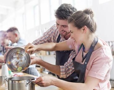 couple cooking in cooking class